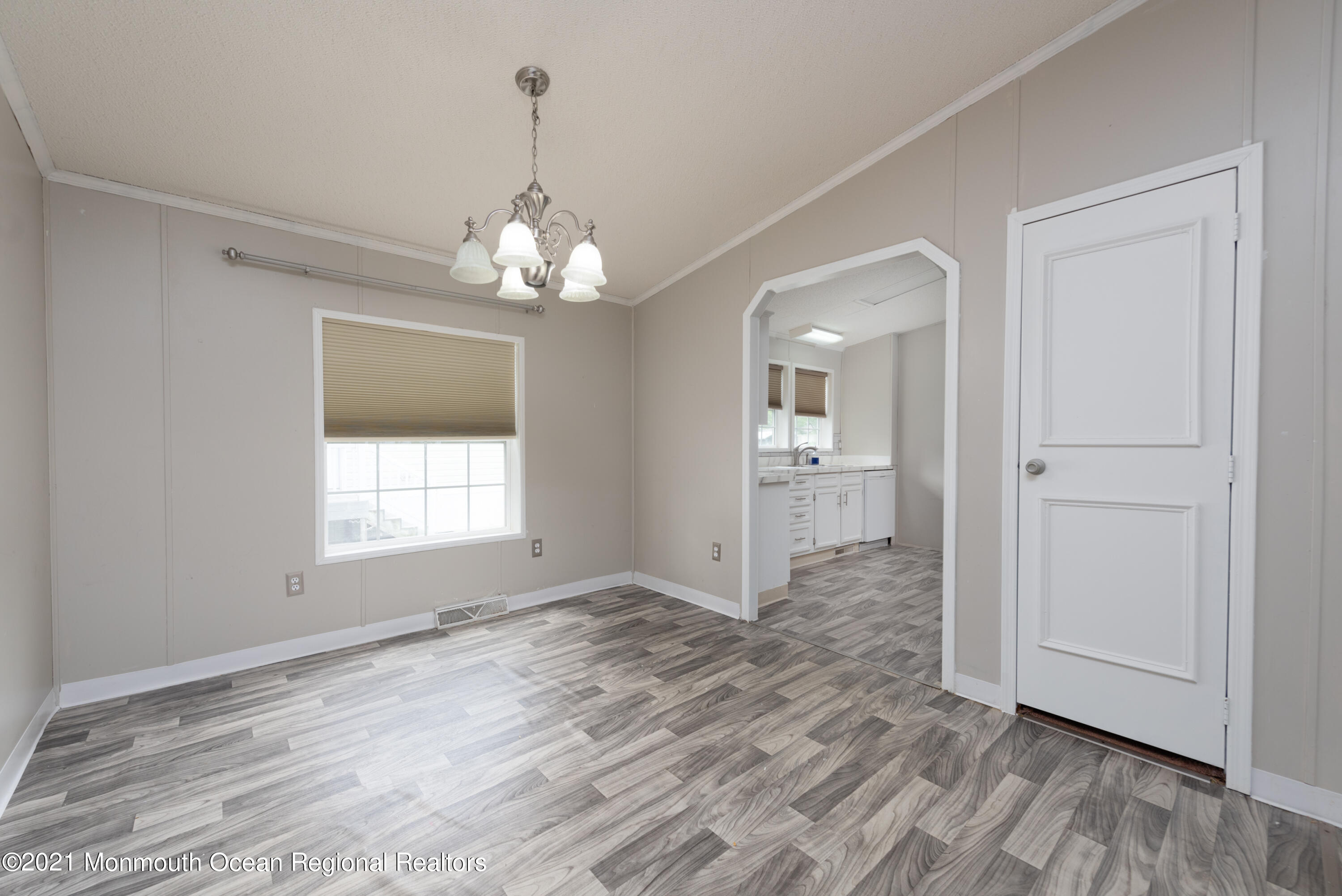 90 Village Road Morganville, NJ 07751 - Photo 4 of 25 wooden floor in an empty room with a window