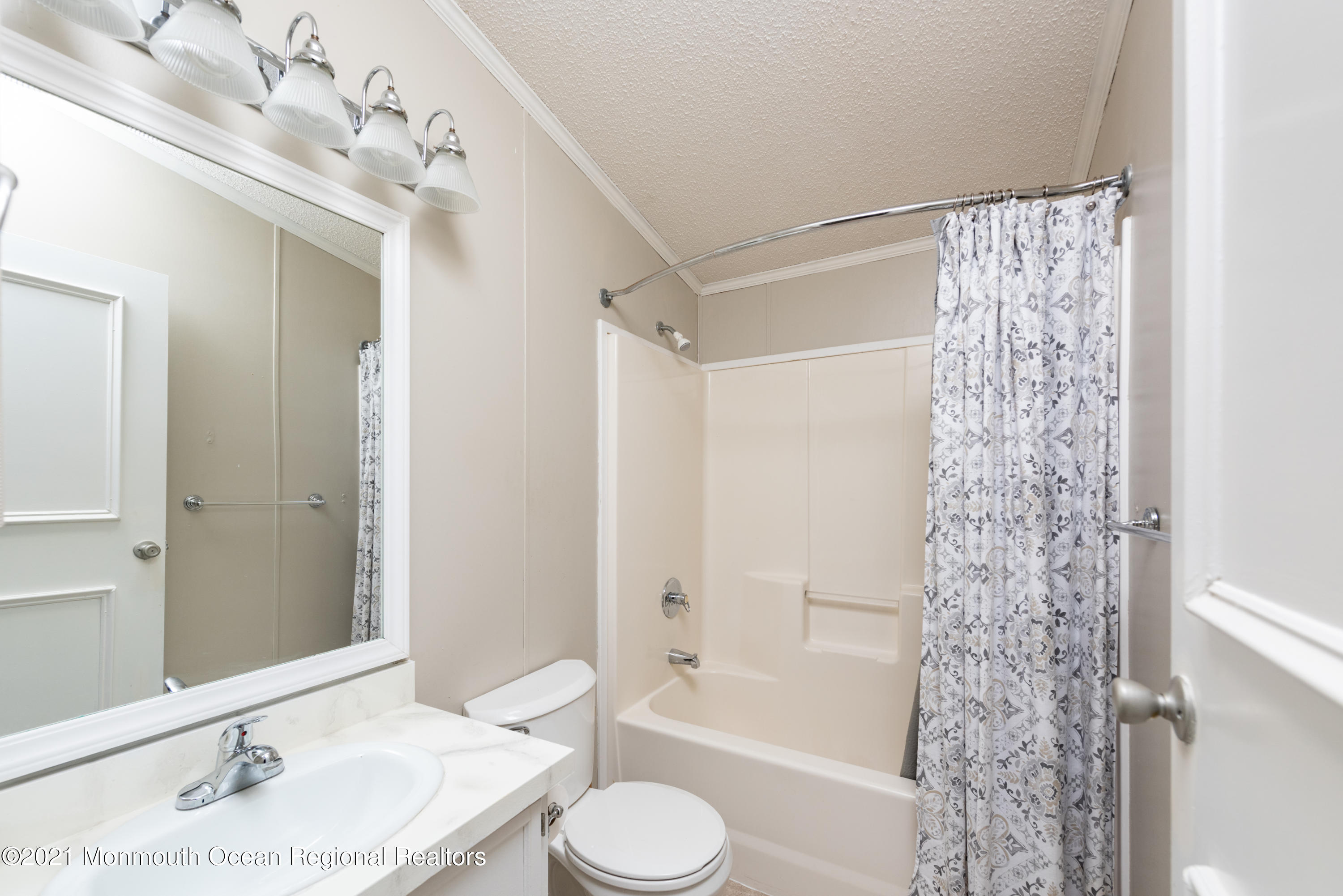 90 Village Road Morganville, NJ 07751 - Photo 10 of 25 a bathroom with a granite countertop sink toilet and shower