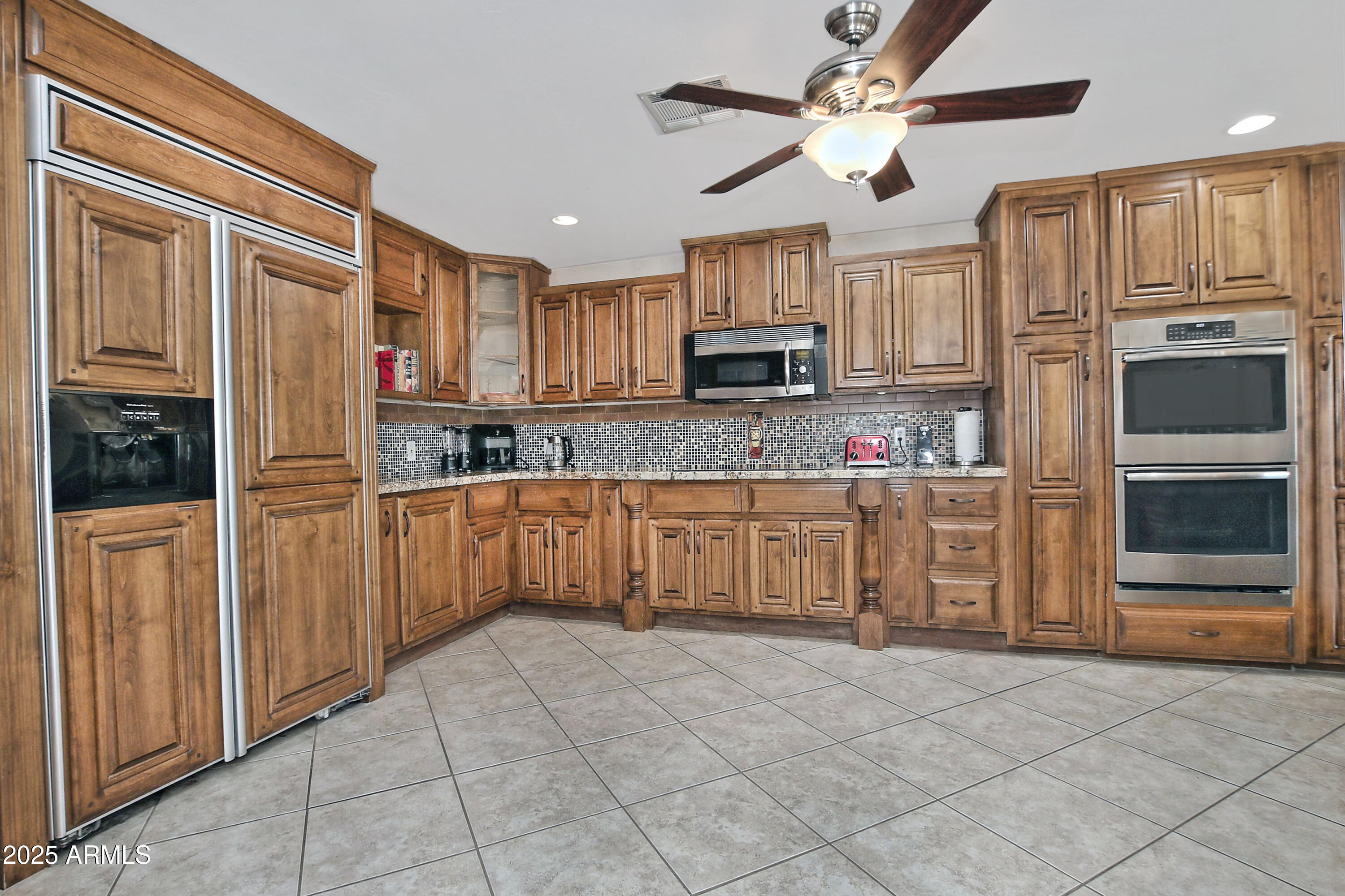 4301 East Sacaton Street Phoenix, AZ 85044 - Photo 7 of 17 a kitchen with stainless steel appliances a refrigerator sink and microwave