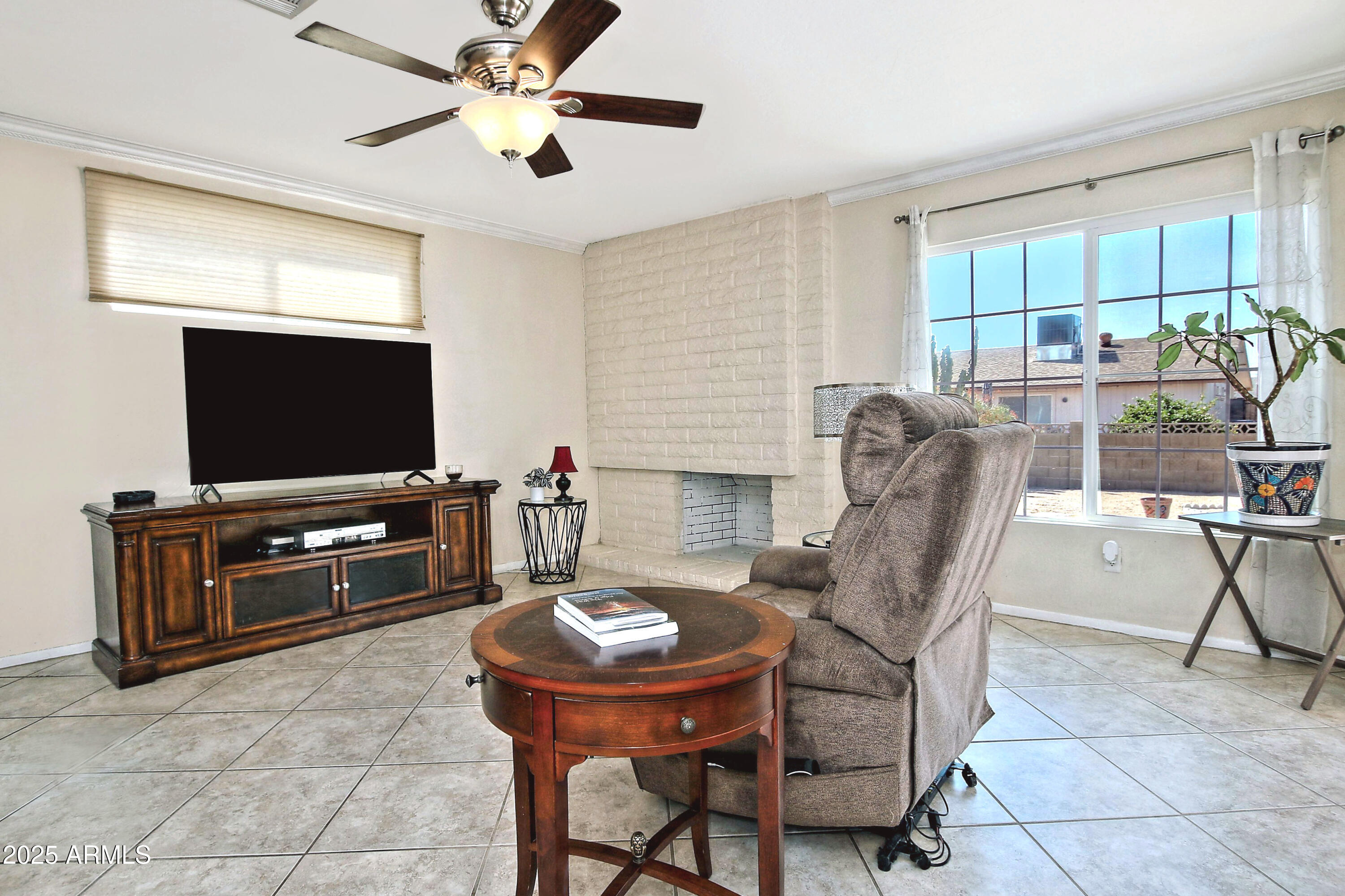 4301 East Sacaton Street Phoenix, AZ 85044 - Photo 10 of 17 a living room with furniture and a flat screen tv