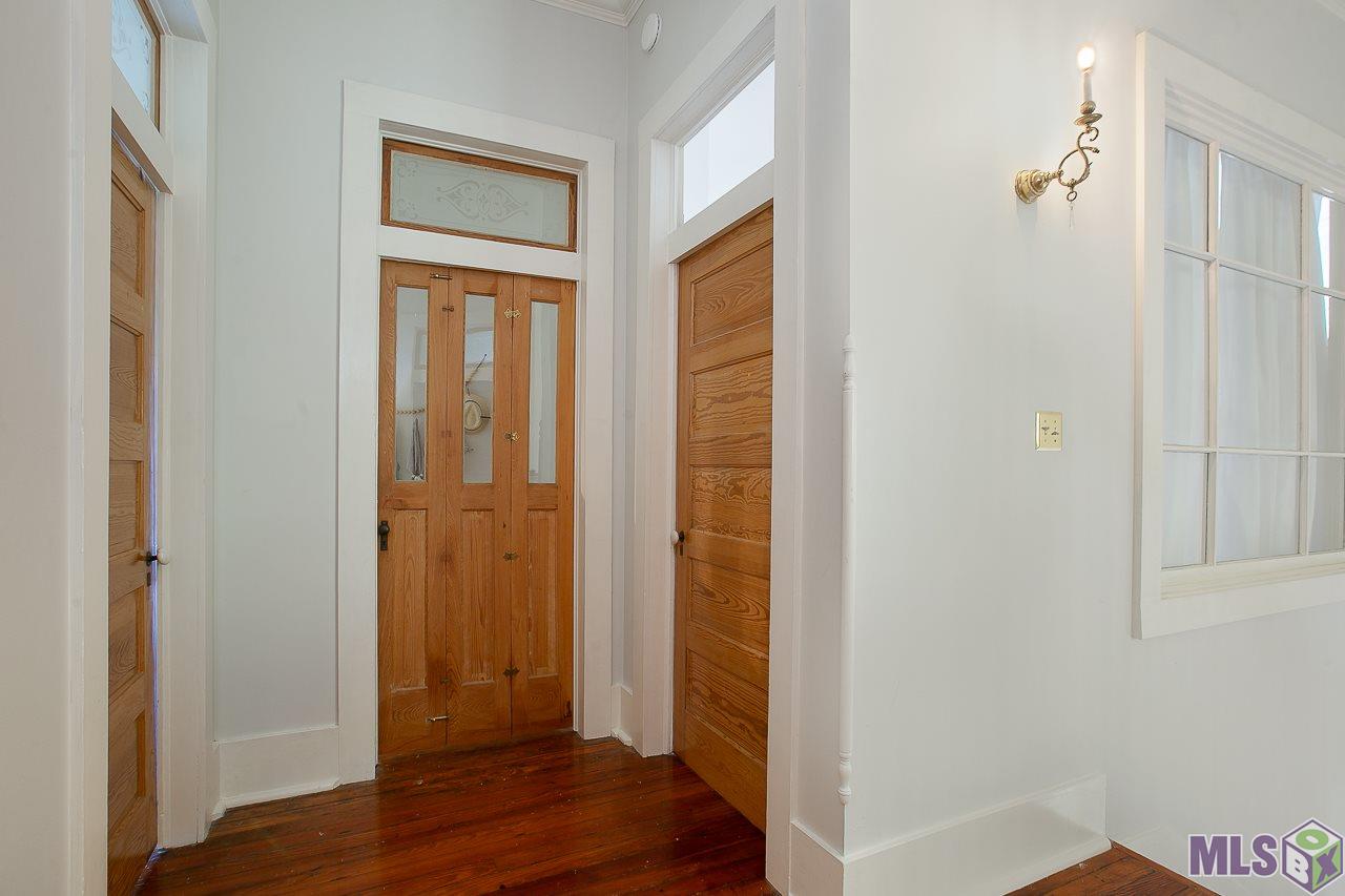 8325 Highland Road Baton Rouge, LA 70808 - Photo 31 of 34 Upstairs Hall....Cypress Doors and Transoms.