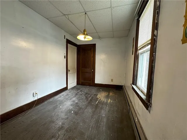 a view of a room with wooden floor