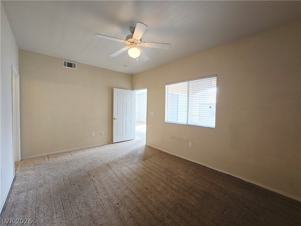 9580 West Reno Avenue, Unit 283 Las Vegas, NV 89148 - Photo 11 of 19 Spare room featuring a ceiling fan and carpet floors