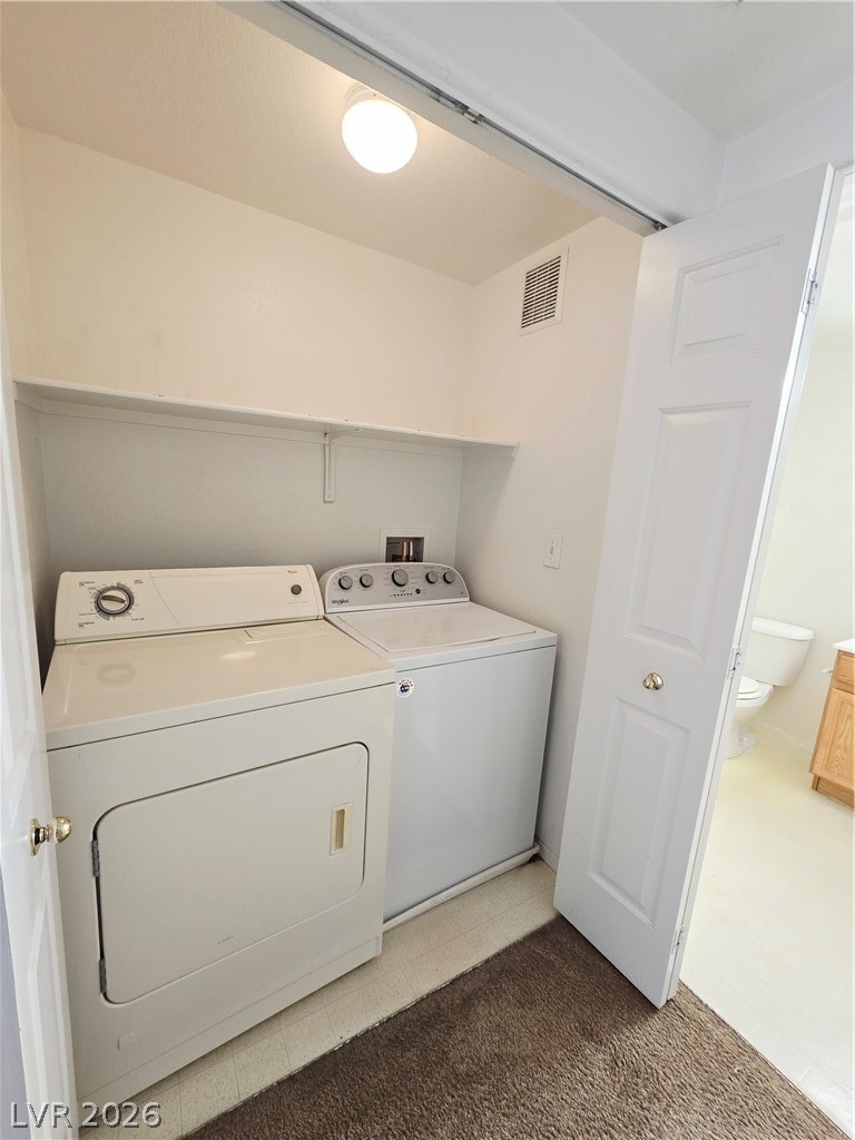 9580 West Reno Avenue, Unit 283 Las Vegas, NV 89148 - Photo 14 of 19 Laundry area with washer and dryer and light colored carpet