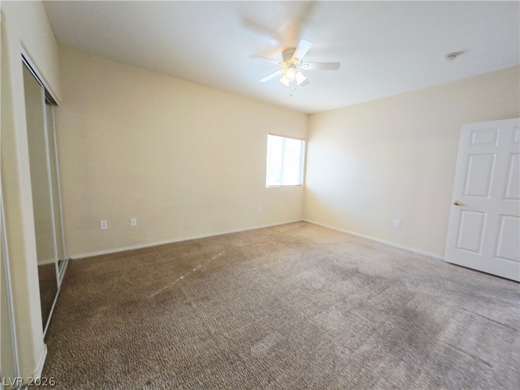 9580 West Reno Avenue, Unit 283 Las Vegas, NV 89148 - Photo 16 of 19 Unfurnished bedroom with carpet, ceiling fan, and a closet