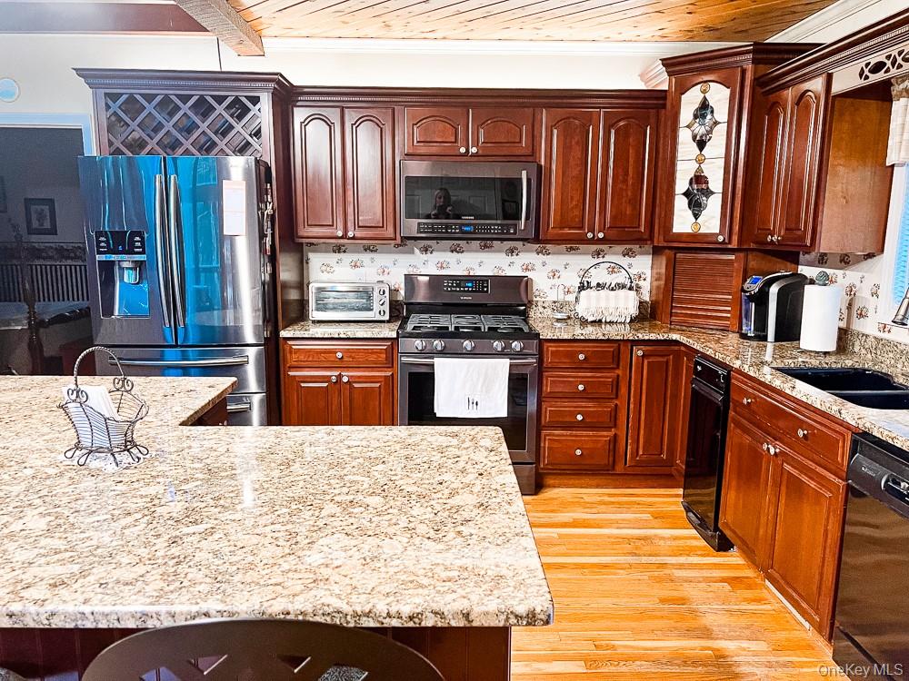 100 Old Tacy Road, Unit TR95 Bethel, NY 12783 - Photo 12 of 50 Kitchen featuring stainless steel appliances, light wood-style flooring, wooden ceiling, light stone countertops, and crown molding