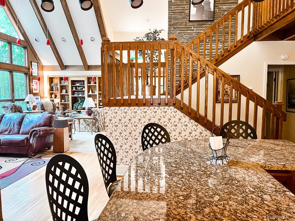 100 Old Tacy Road, Unit TR95 Bethel, NY 12783 - Photo 18 of 50 Living area with high vaulted ceiling, beamed ceiling, and wood finished floors