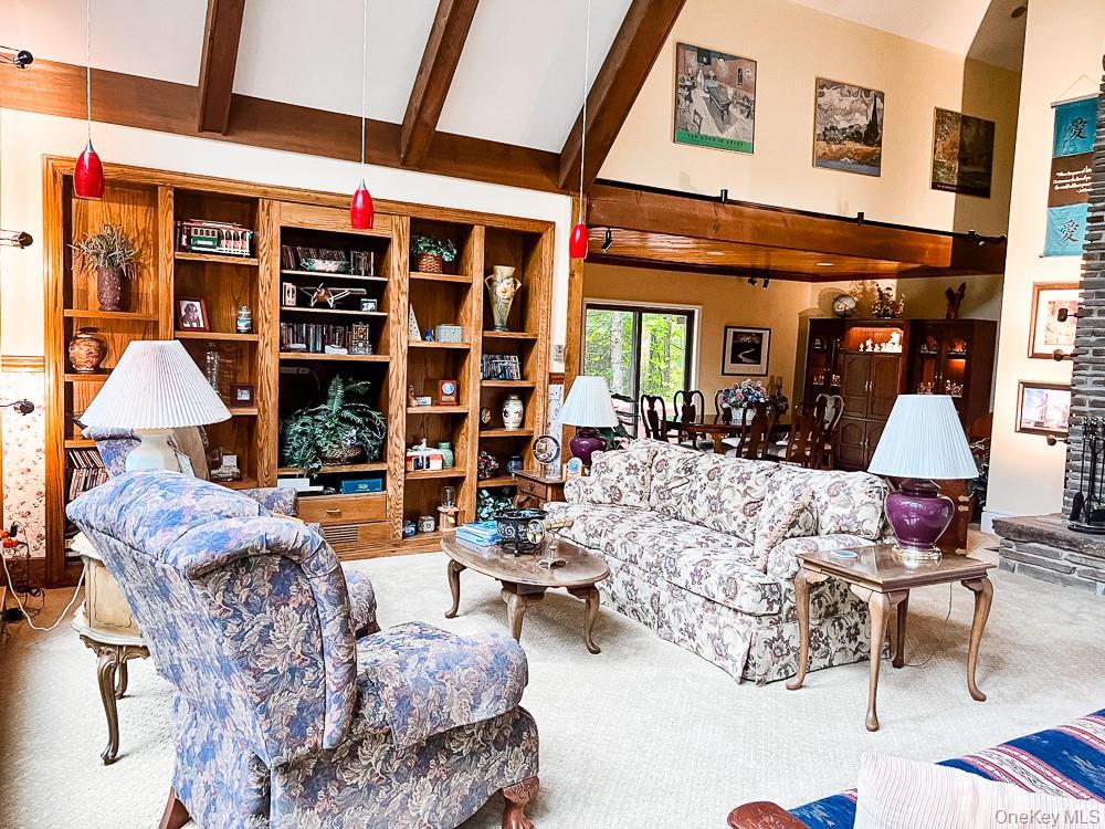100 Old Tacy Road, Unit TR95 Bethel, NY 12783 - Photo 29 of 50 Living area featuring carpet flooring, high vaulted ceiling, and beamed ceiling