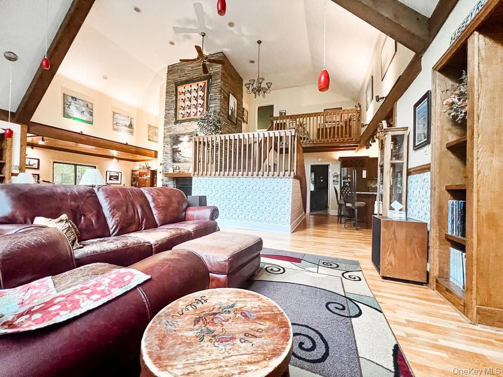 100 Old Tacy Road, Unit TR95 Bethel, NY 12783 - Photo 3 of 50 Living area featuring ceiling fan, light wood-style flooring, and high vaulted ceiling
