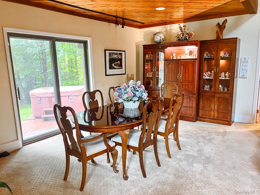 100 Old Tacy Road, Unit TR95 Bethel, NY 12783 - Photo 31 of 50 Dining area with wood ceiling and light carpet
