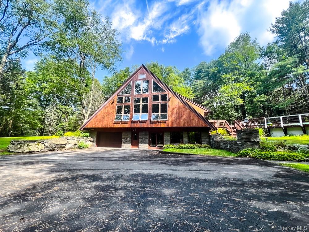 100 Old Tacy Road, Unit TR95 Bethel, NY 12783 - Photo 4 of 50 View of front facade with asphalt driveway, an attached garage, and stairs