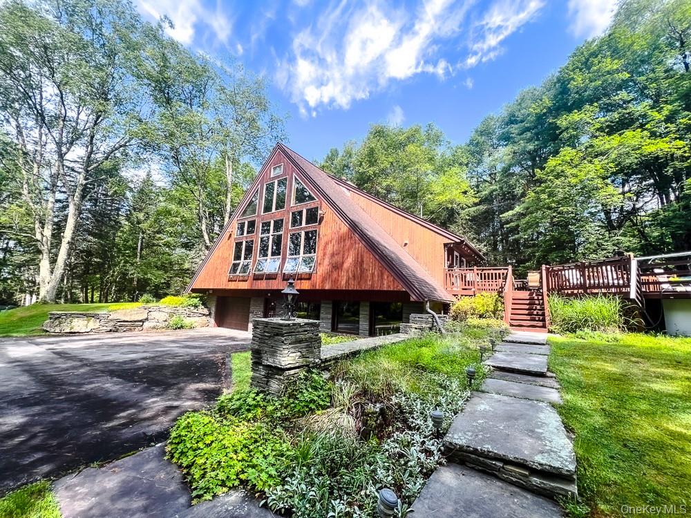 100 Old Tacy Road, Unit TR95 Bethel, NY 12783 - Photo 6 of 50 View of front of home with driveway, stairs, a wooden deck, and a garage