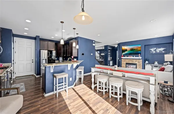 a large kitchen with a table and chairs