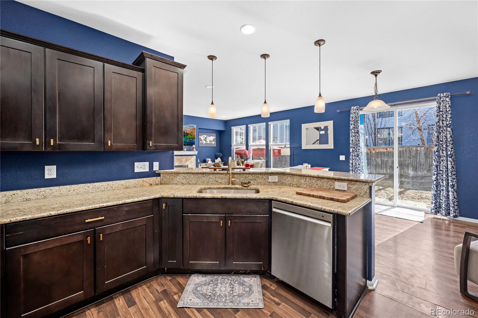13826 West Layton Circle Morrison, CO 80465 - Photo 13 of 43 a kitchen with a sink stove and cabinets