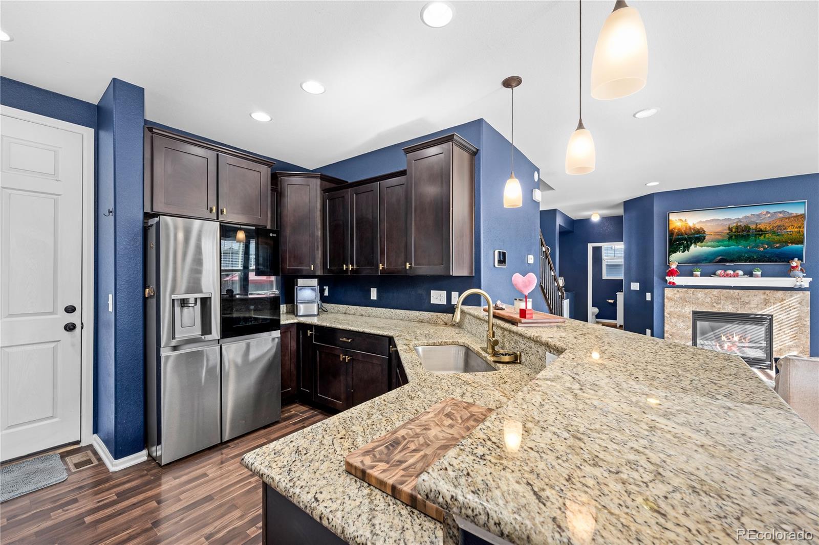 13826 West Layton Circle Morrison, CO 80465 - Photo 14 of 43 a kitchen with stainless steel appliances granite countertop a refrigerator a sink and a stove