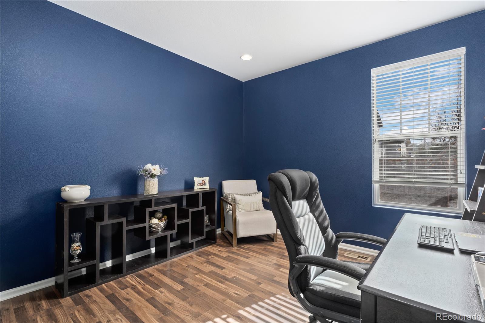 13826 West Layton Circle Morrison, CO 80465 - Photo 16 of 43 a work room with furniture and wooden floor