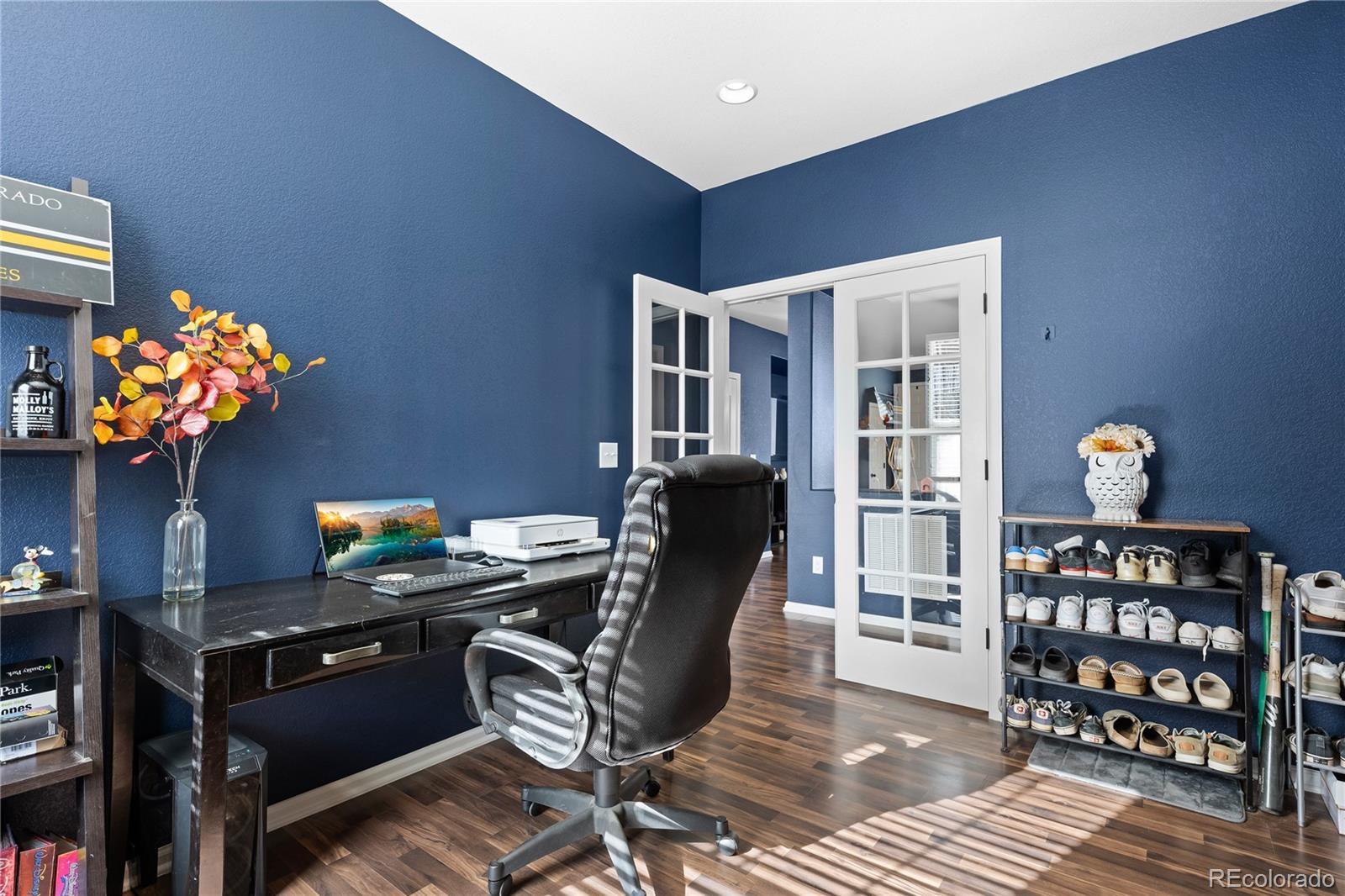 13826 West Layton Circle Morrison, CO 80465 - Photo 17 of 43 a work room with furniture a bookshelf and a window