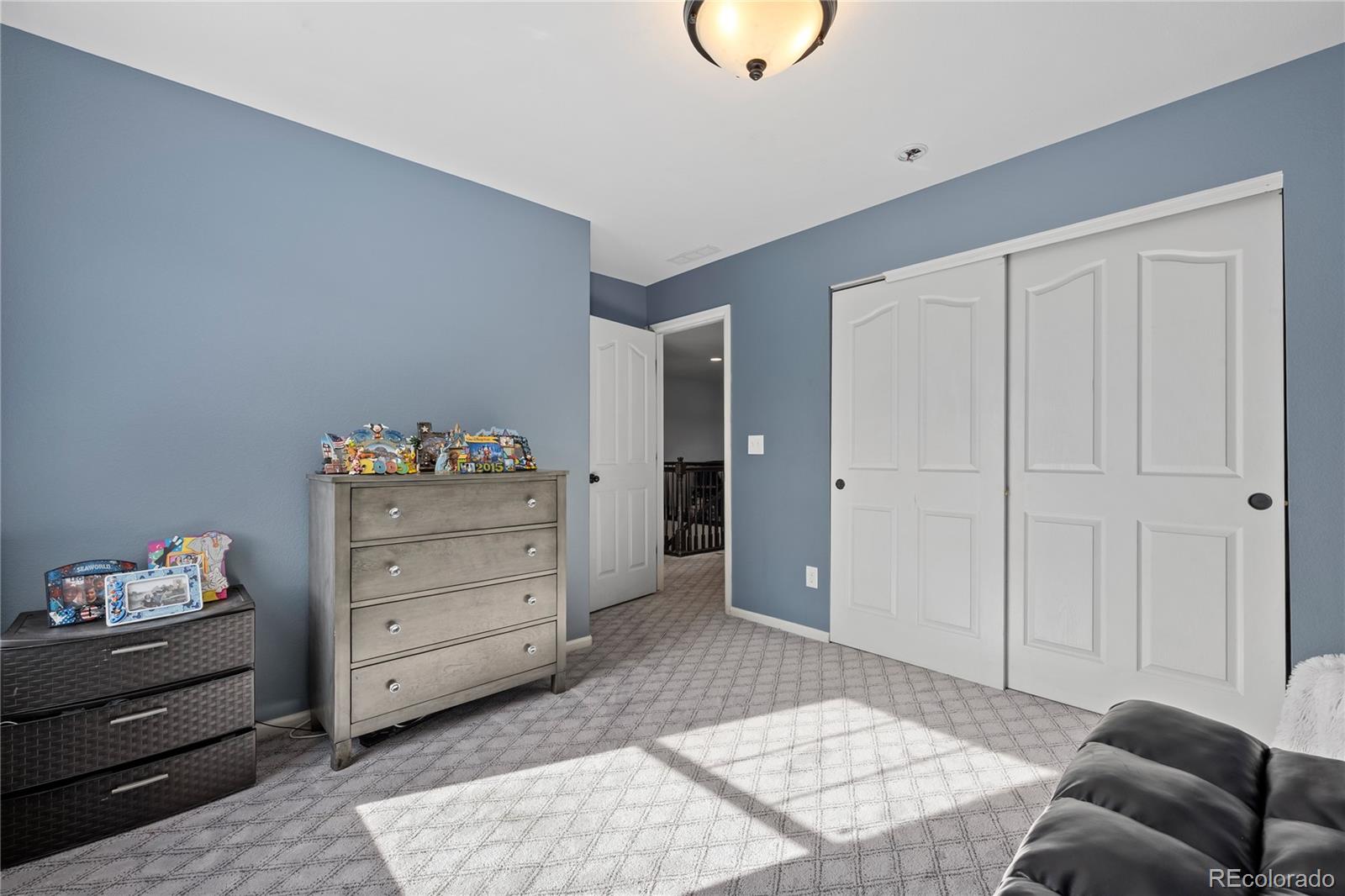 13826 West Layton Circle Morrison, CO 80465 - Photo 22 of 43 a bedroom with a bed and cabinets