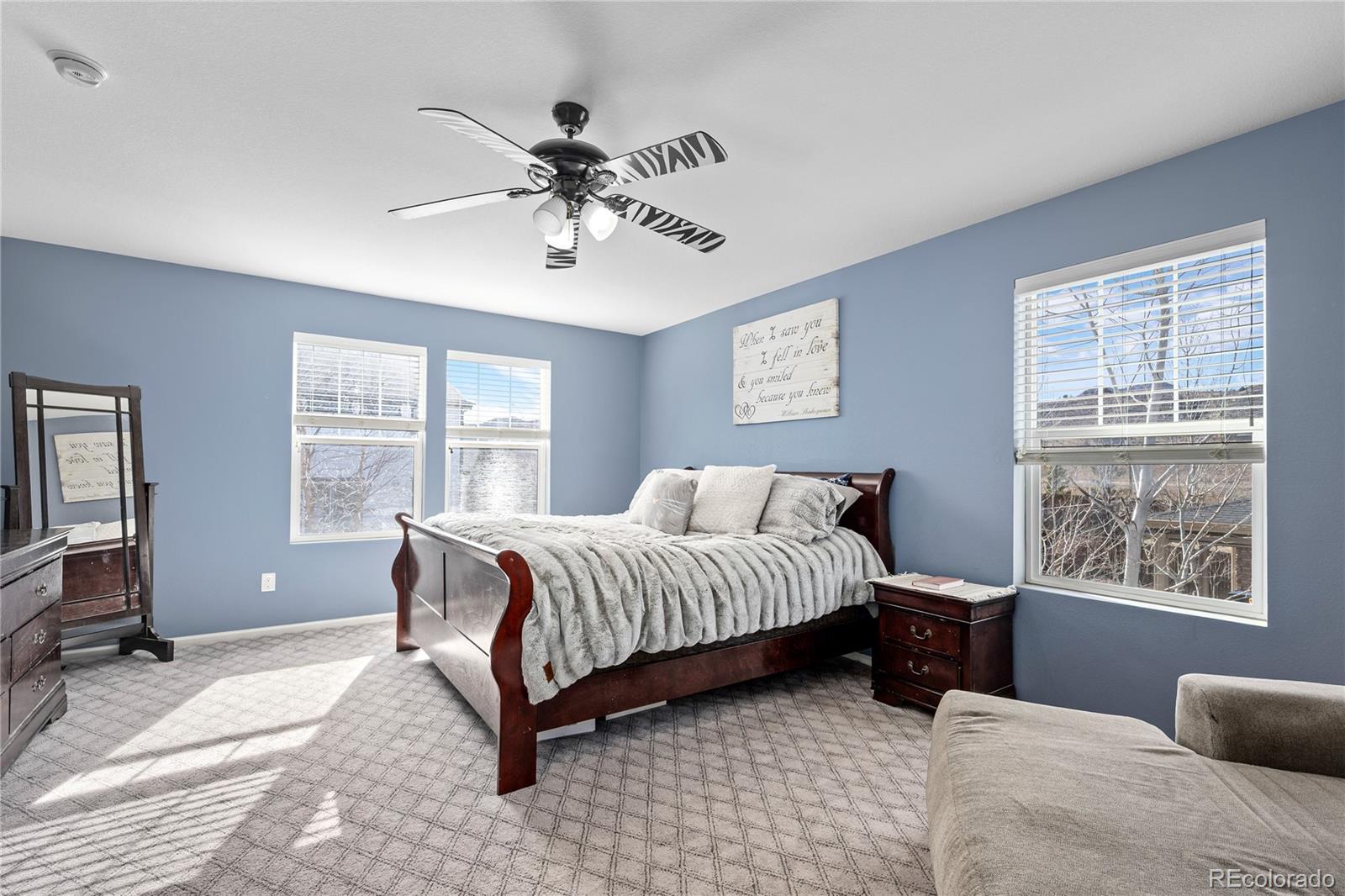 13826 West Layton Circle Morrison, CO 80465 - Photo 23 of 43 a spacious bedroom with a bed and glass window