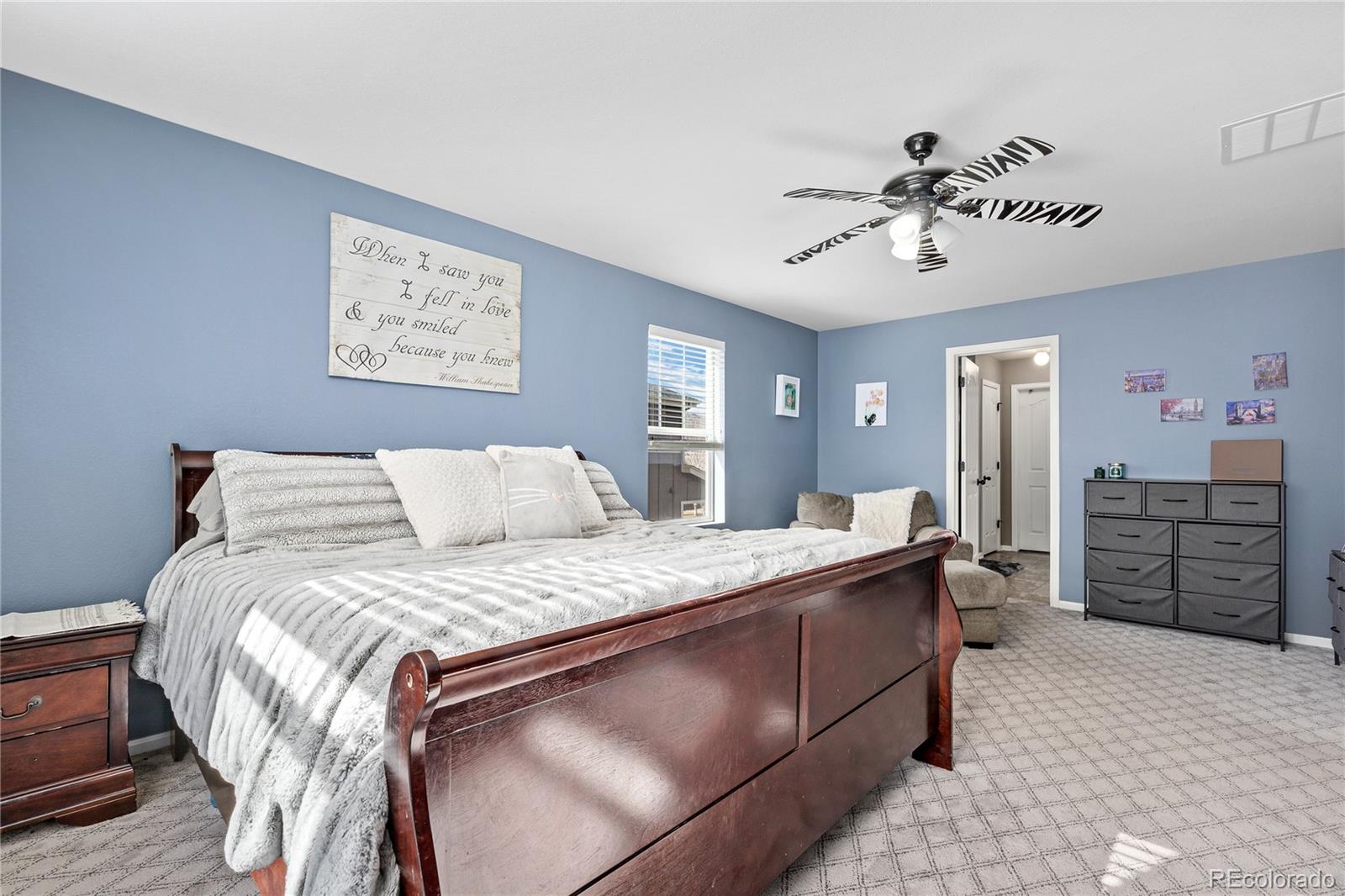 13826 West Layton Circle Morrison, CO 80465 - Photo 24 of 43 a bed room with a bed and dresser