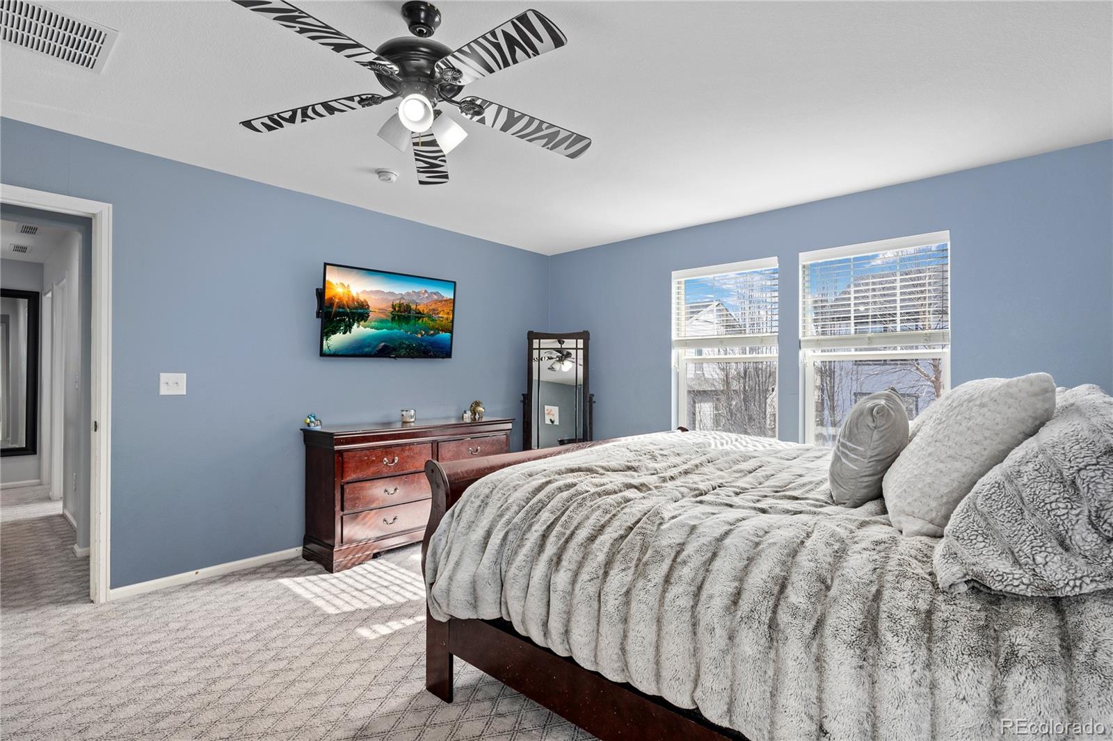 13826 West Layton Circle Morrison, CO 80465 - Photo 25 of 43 a bedroom with a bed and a flat screen tv