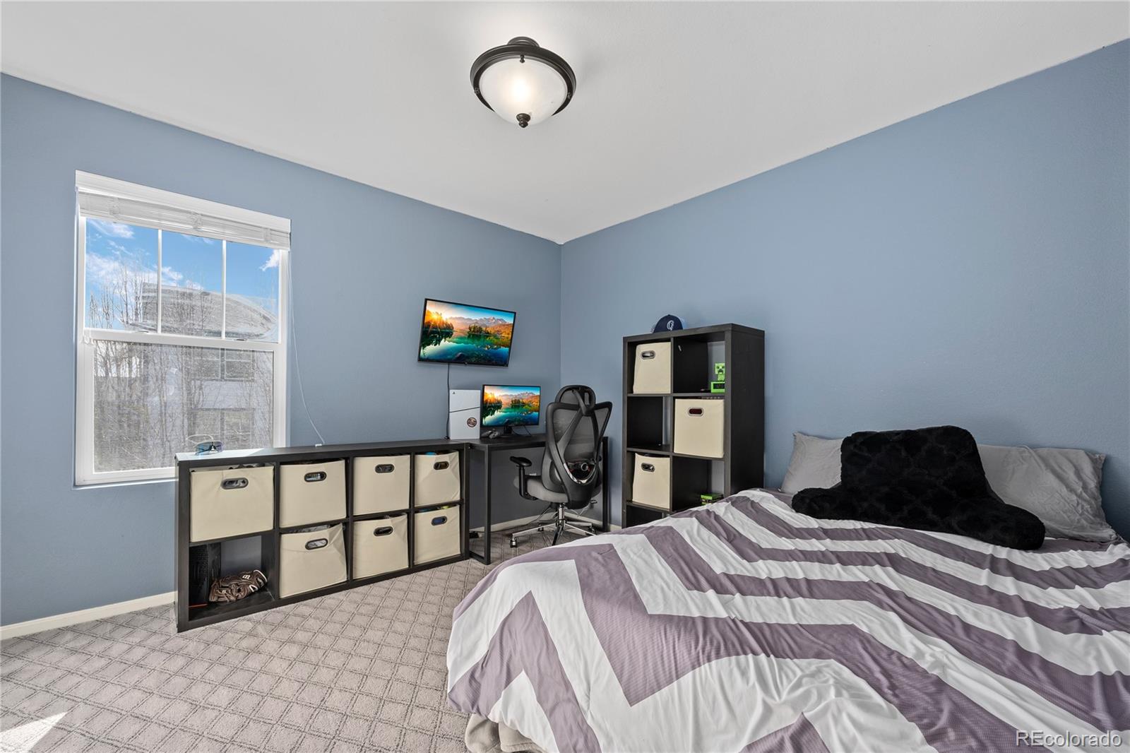 13826 West Layton Circle Morrison, CO 80465 - Photo 31 of 43 a bedroom with a bed and dresser