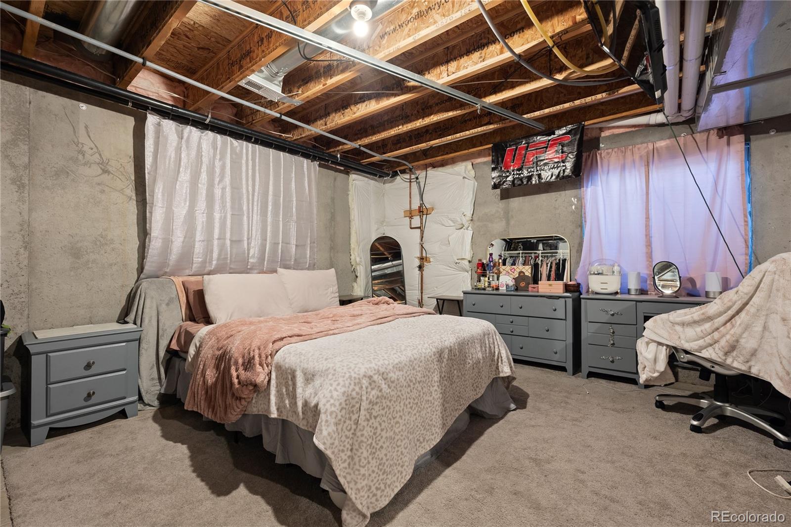 13826 West Layton Circle Morrison, CO 80465 - Photo 36 of 43 a bed room with a bed and a chair