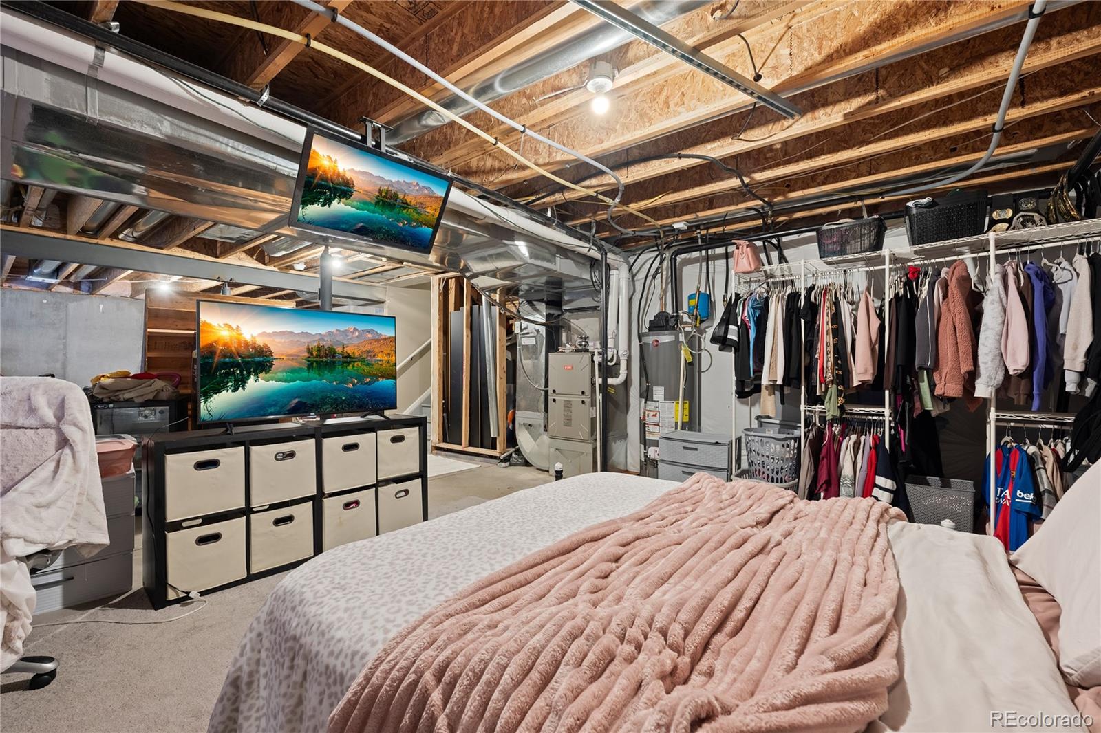 13826 West Layton Circle Morrison, CO 80465 - Photo 37 of 43 a bed room with a bed and a chair