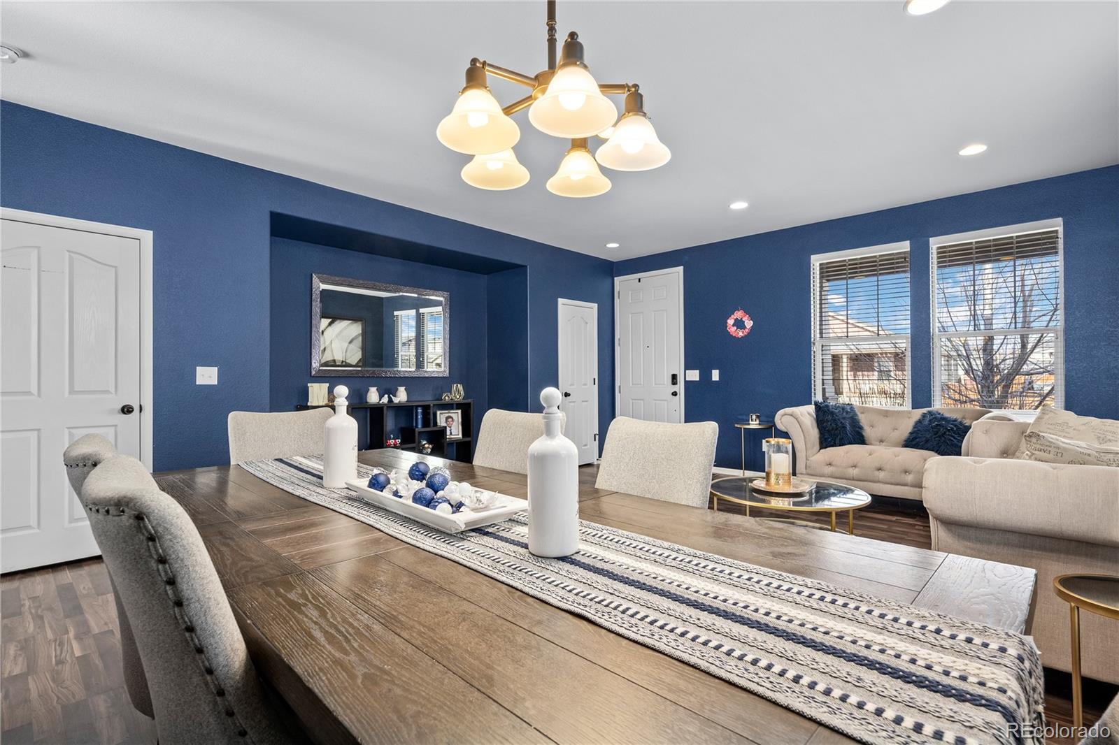 13826 West Layton Circle Morrison, CO 80465 - Photo 5 of 43 a living room with furniture chandelier and a view of kitchen
