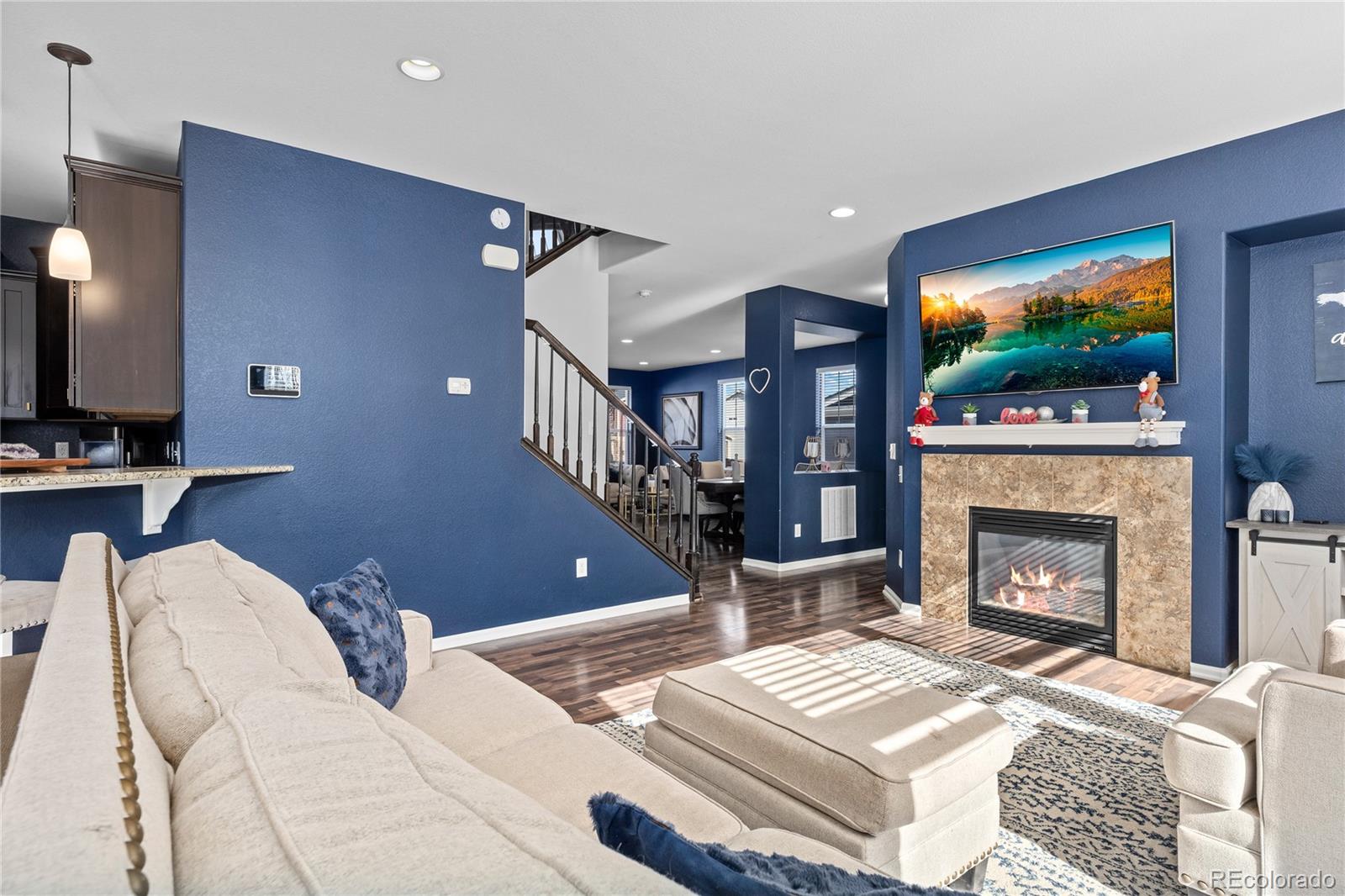 13826 West Layton Circle Morrison, CO 80465 - Photo 8 of 43 a living room with furniture a flat screen tv and a fireplace