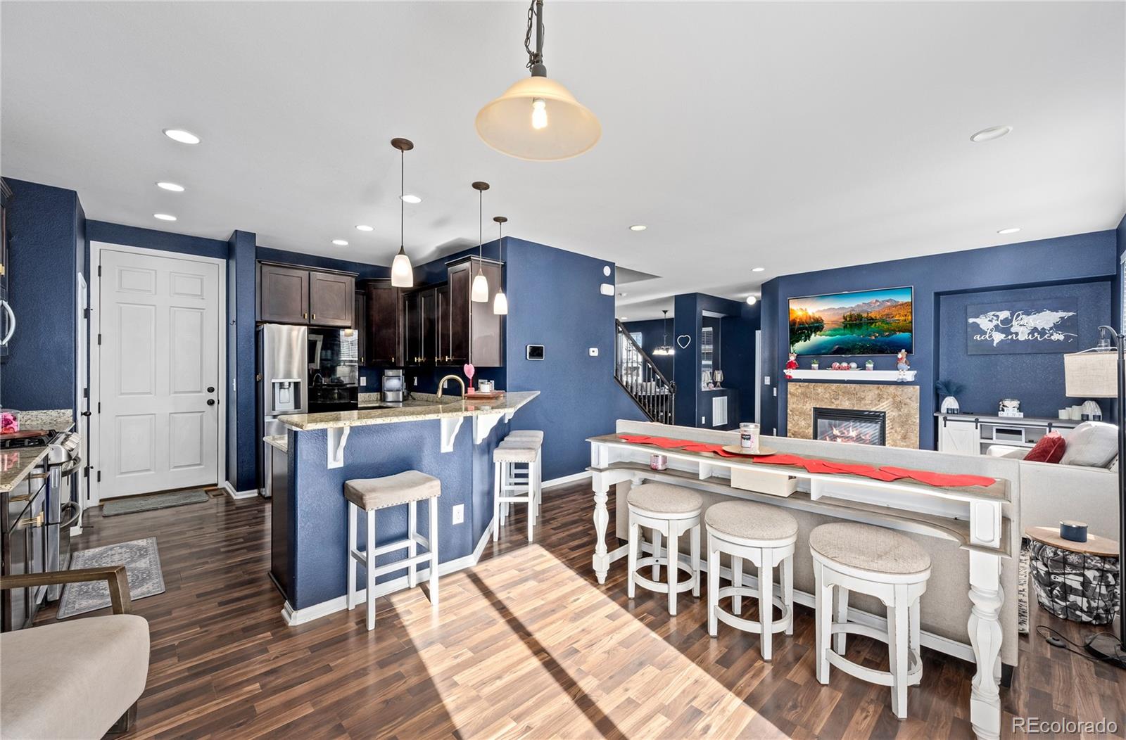 13826 West Layton Circle Morrison, CO 80465 - Photo 10 of 43 a large kitchen with a table and chairs