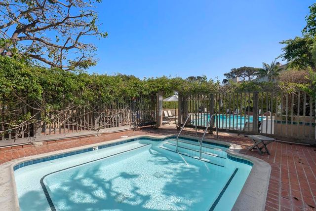 a view of a swimming pool and lounge chair