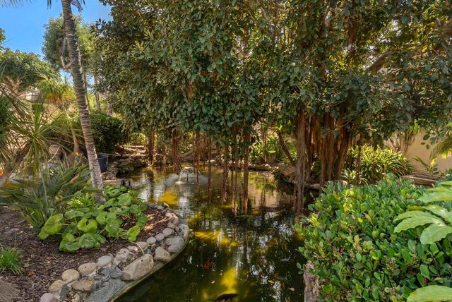 an aerial view of house with yard and ocean view