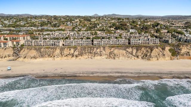 a street sign on a wall next to a road