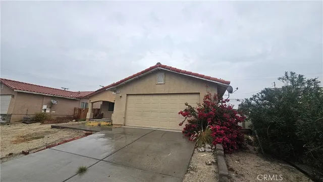 a backyard of a house with flower plants