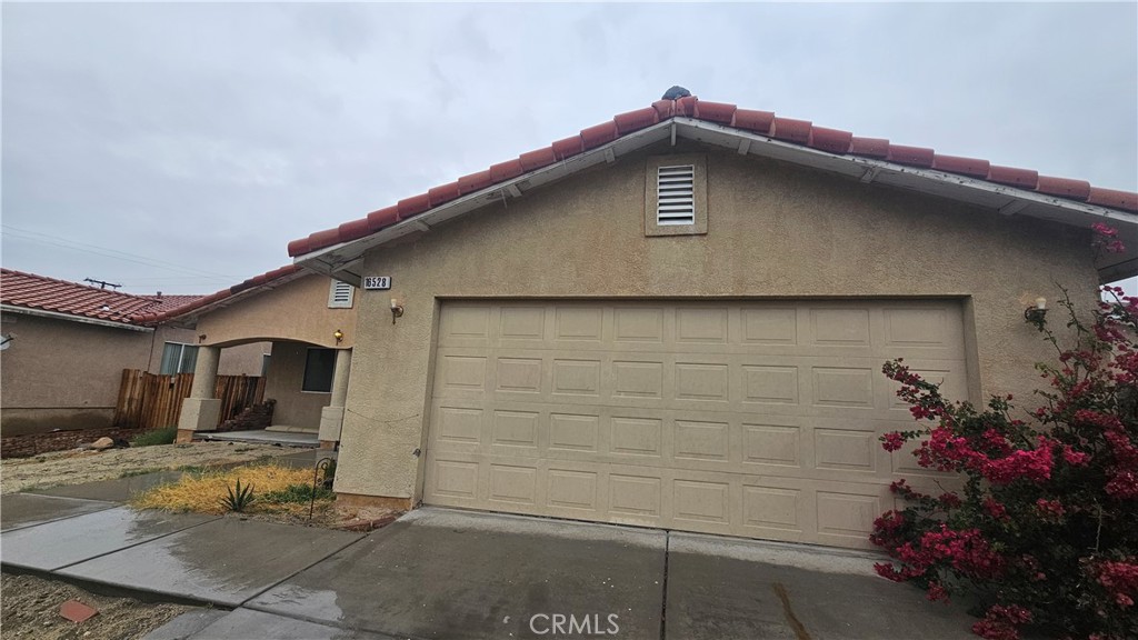 16528 Avenida Mirola Desert Hot Springs, CA 92240 - Photo 2 of 9 a front view of a house with a yard