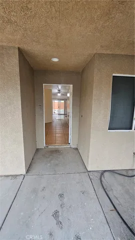 a view of a hallway with entryway door