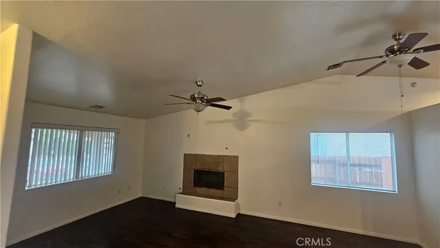 a kitchen with a sink a stove cabinets and wooden floor