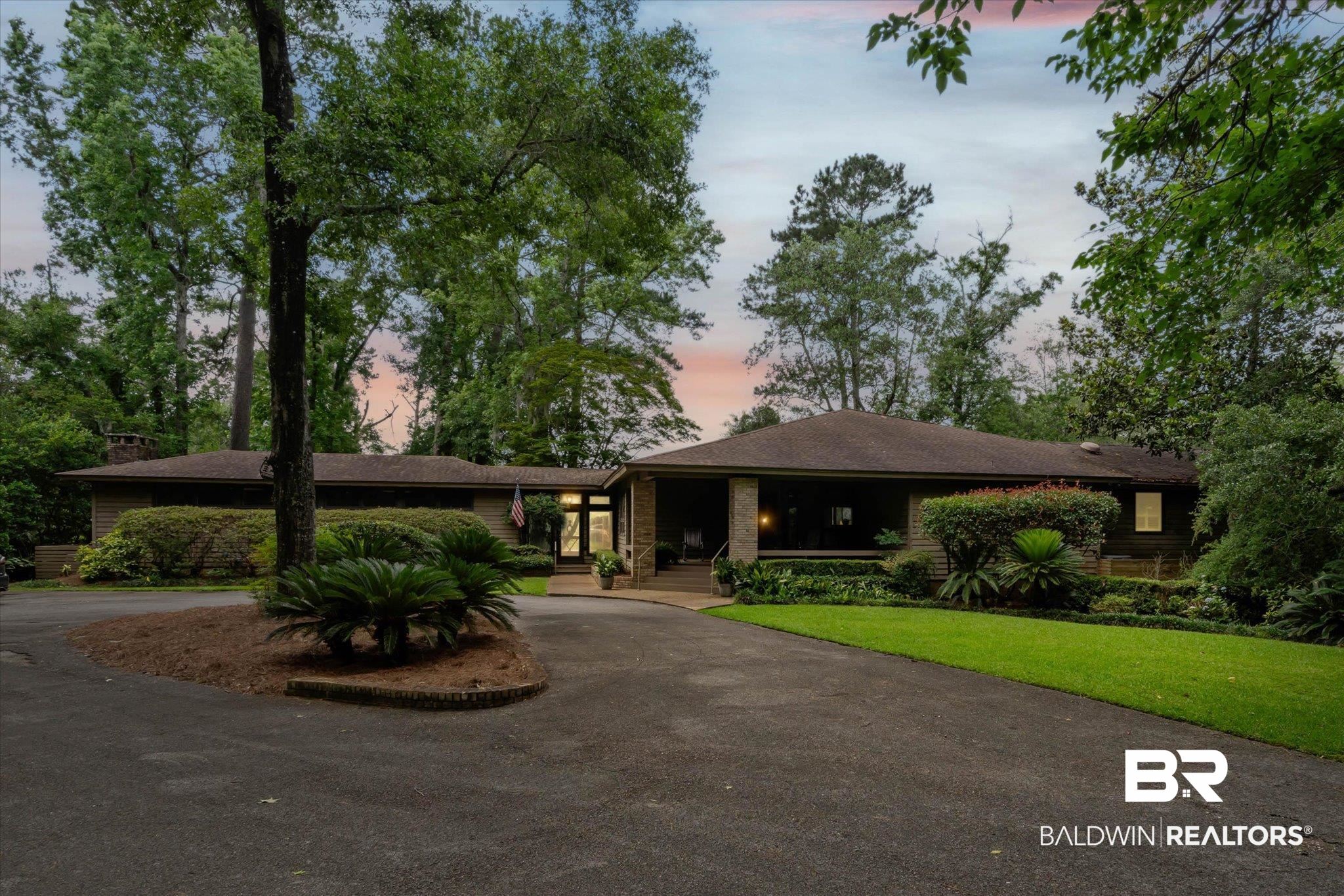 3500 Venetia Road Mobile, AL 36605 - Photo 39 of 56 Ranch-style residence featuring a dark shingle roof, a paved circular driveway, mature trees, and a well-maintained lawn