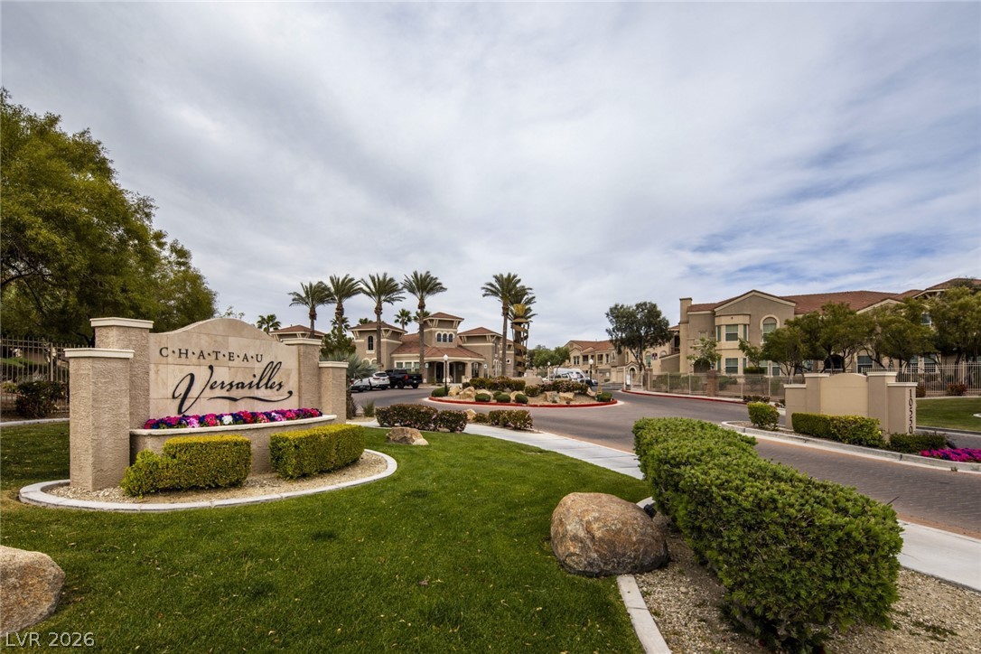 10550 West Alexander Road, Unit 1097 Las Vegas, NV 89129 - Photo 33 of 37 Lush landscaping and manicured pathways frame the stone entry gates of this secure residential community.