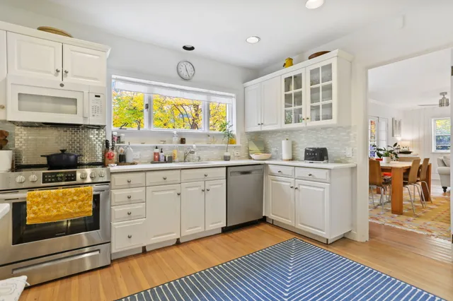 a kitchen with a stove window and cabinets