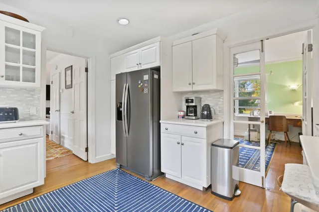 a kitchen with white cabinets and stainless steel appliances