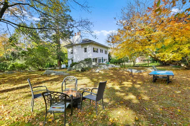 a view of a house with pool and sitting area