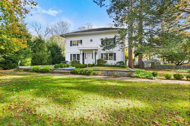 a front view of a house with a yard table and chairs