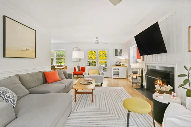 a living room with fireplace furniture and a flat screen tv