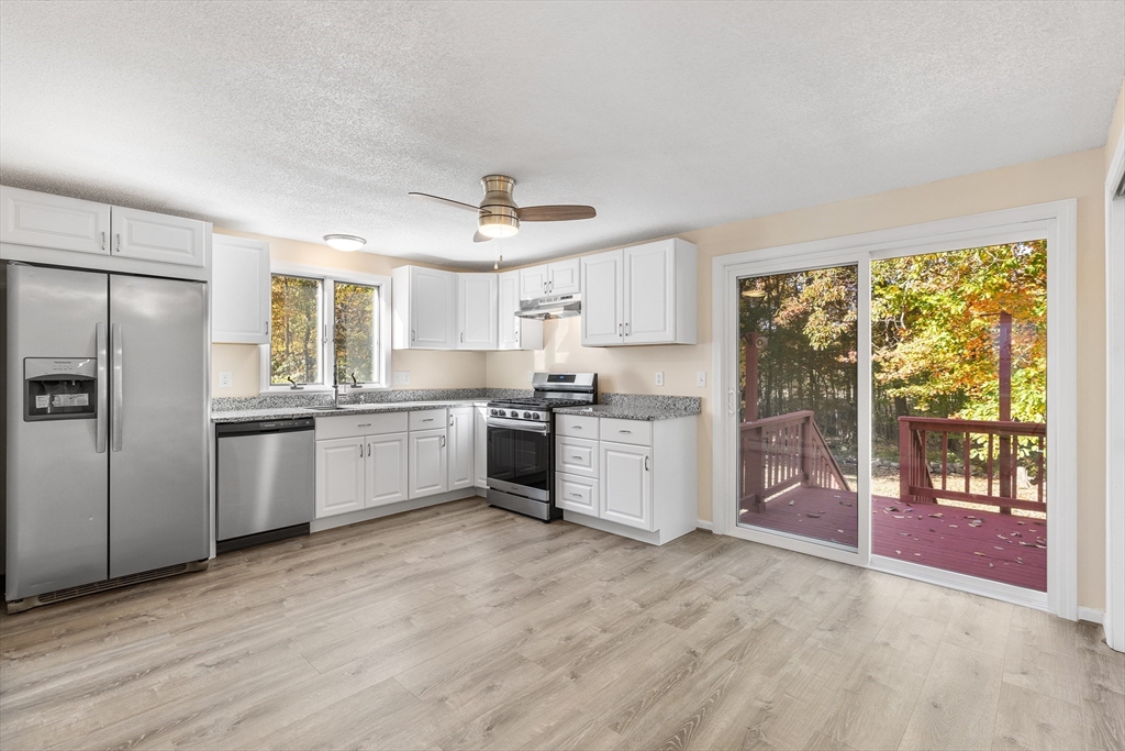 56 Vincent Circle Worcester, MA 01604 - Photo 2 of 23 a kitchen with a refrigerator a sink and cabinets