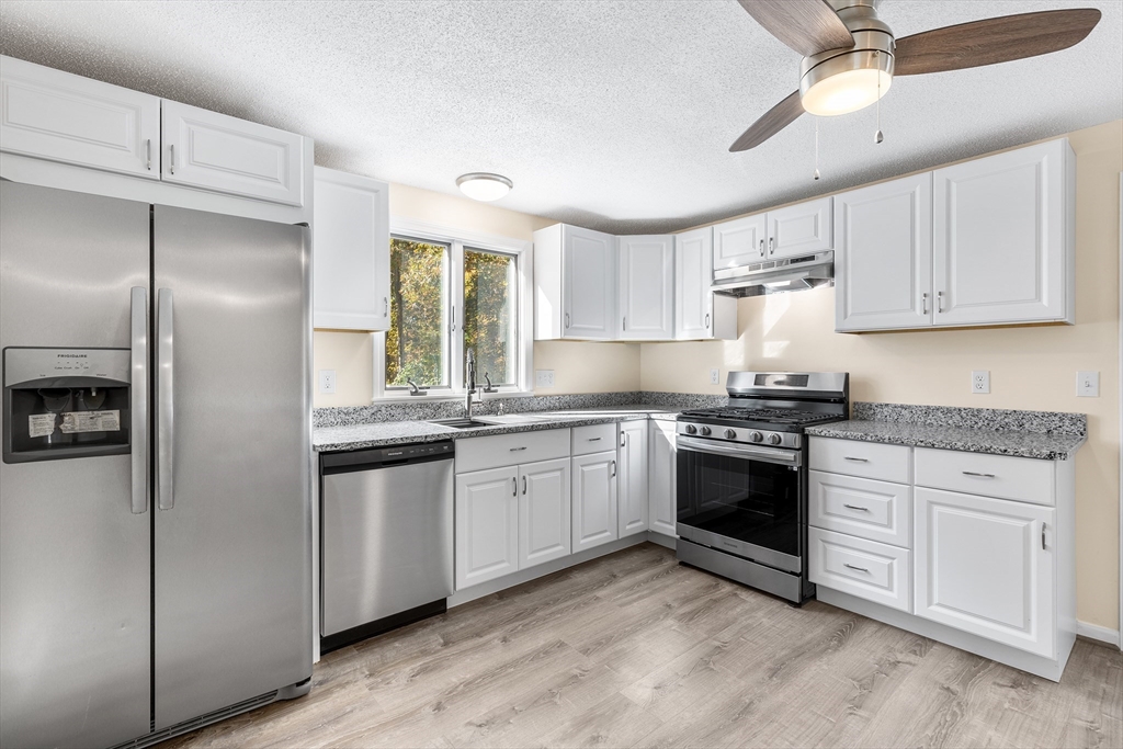56 Vincent Circle Worcester, MA 01604 - Photo 4 of 23 a kitchen with granite countertop a sink stainless steel appliances and counter space