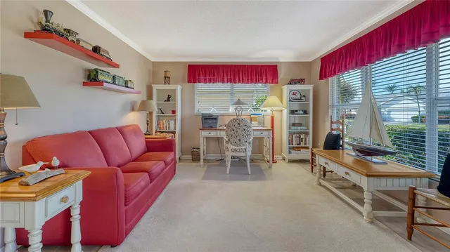 a living room with furniture and a floor to ceiling window