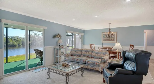 a kitchen with stainless steel appliances granite countertop white cabinets sink and window