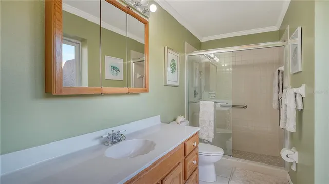 a bathroom with a sink vanity mirror and toilet